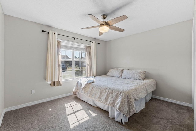 bedroom with a ceiling fan, carpet flooring, and baseboards