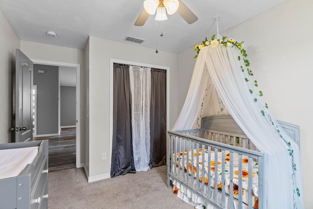 carpeted bedroom featuring baseboards, visible vents, ceiling fan, and a closet