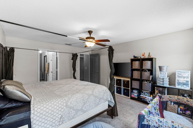 bedroom with ceiling fan, a textured ceiling, and carpet flooring