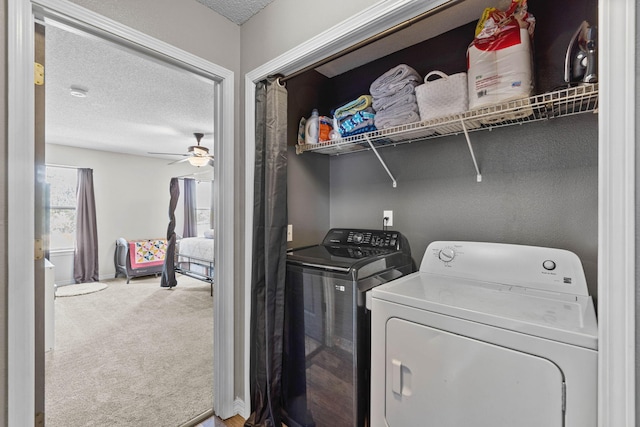 clothes washing area featuring carpet flooring, ceiling fan, a textured ceiling, separate washer and dryer, and laundry area