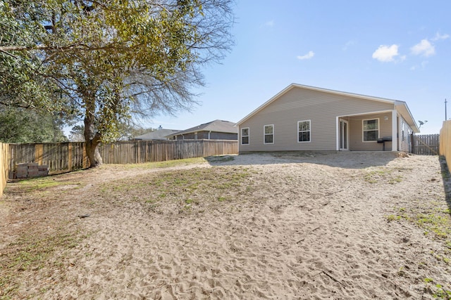 back of property with a fenced backyard