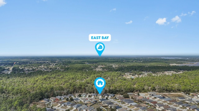 bird's eye view featuring a residential view and a wooded view