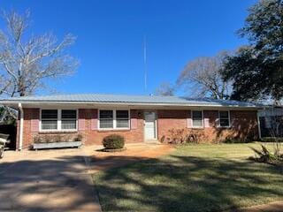 single story home with brick siding and a front lawn