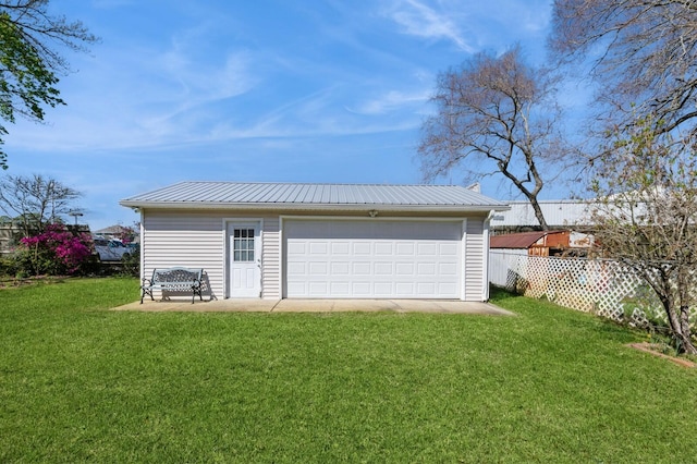 detached garage featuring fence