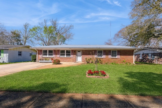 single story home with a front lawn, brick siding, and driveway