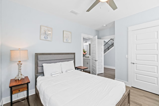 bedroom featuring a ceiling fan, wood finished floors, visible vents, and baseboards