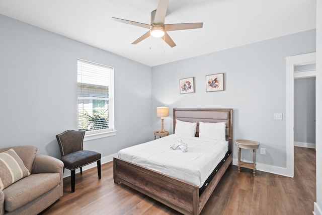 bedroom featuring ceiling fan, wood finished floors, and baseboards