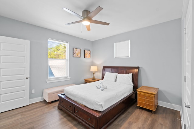 bedroom with a ceiling fan, baseboards, and wood finished floors