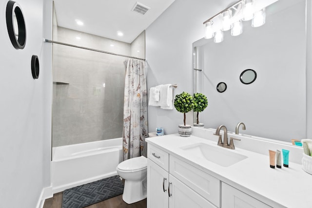 full bath featuring toilet, visible vents, shower / bath combo with shower curtain, and vanity