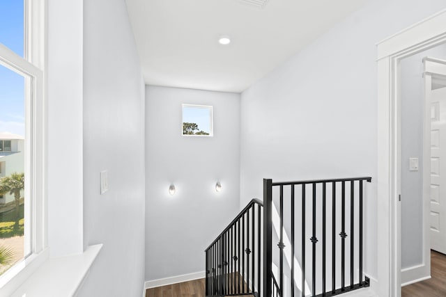 stairs featuring wood finished floors and baseboards