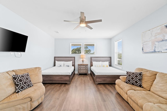 bedroom with a ceiling fan and wood finished floors