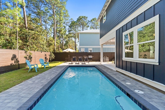 view of pool featuring a fenced backyard, a fenced in pool, and a patio