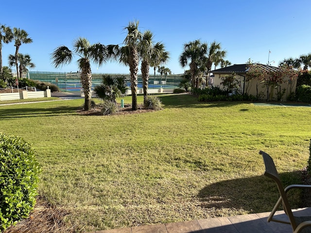 view of home's community with a yard