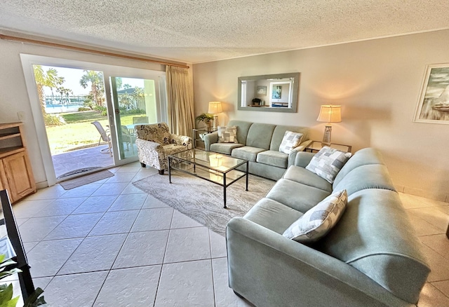 living area featuring a textured ceiling and light tile patterned floors