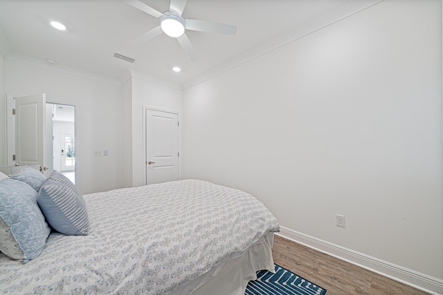 bedroom with recessed lighting, wood finished floors, visible vents, baseboards, and crown molding