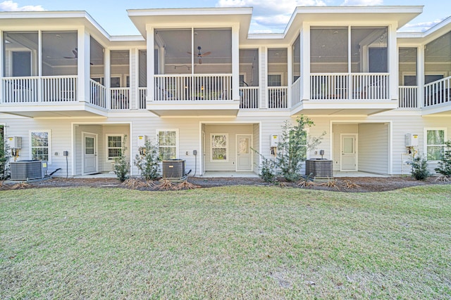 view of front of property with central AC unit and a front lawn