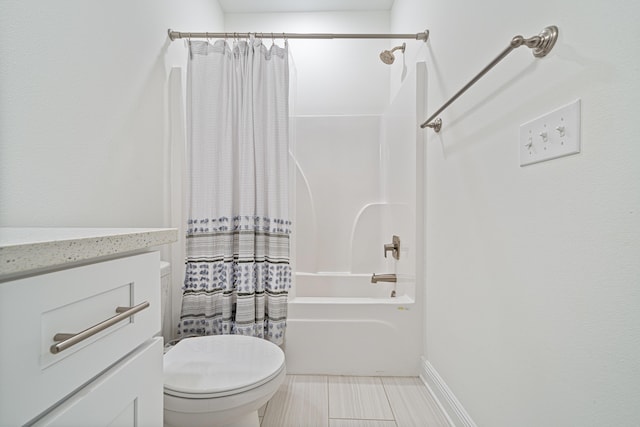 bathroom featuring toilet, shower / bath combo with shower curtain, and vanity