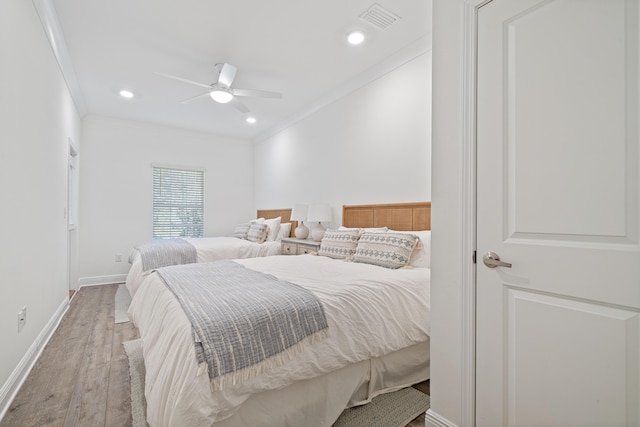 bedroom featuring ornamental molding, wood finished floors, visible vents, and recessed lighting