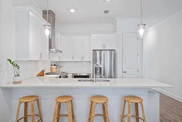 kitchen featuring stove, a sink, visible vents, ornamental molding, and stainless steel refrigerator with ice dispenser