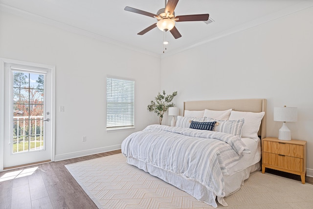 bedroom featuring crown molding, ceiling fan, wood finished floors, access to outside, and baseboards