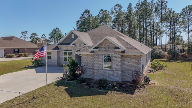 279 Tournament Ln, Freeport, FL 32439 - view of front facade featuring brick siding, a front lawn, and roof with shingles