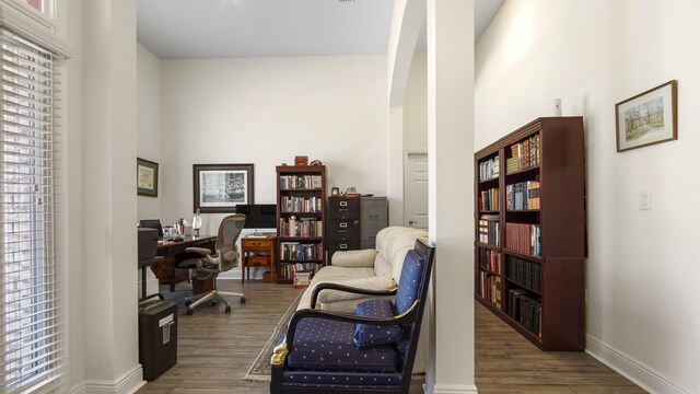 279 Tournament Ln, Freeport, FL 32439 - office area featuring baseboards, arched walkways, and wood finished floors