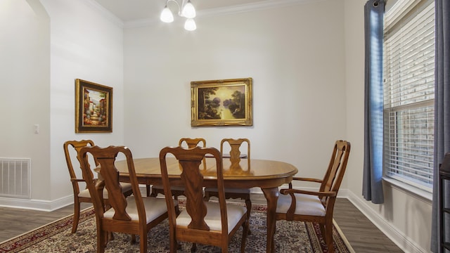 279 Tournament Ln, Freeport, FL 32439 - dining area featuring dark wood finished floors, visible vents, crown molding, and baseboards
