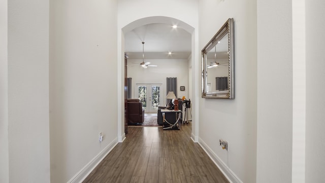 279 Tournament Ln, Freeport, FL 32439 - hall with arched walkways, french doors, dark wood-style flooring, a high ceiling, and baseboards