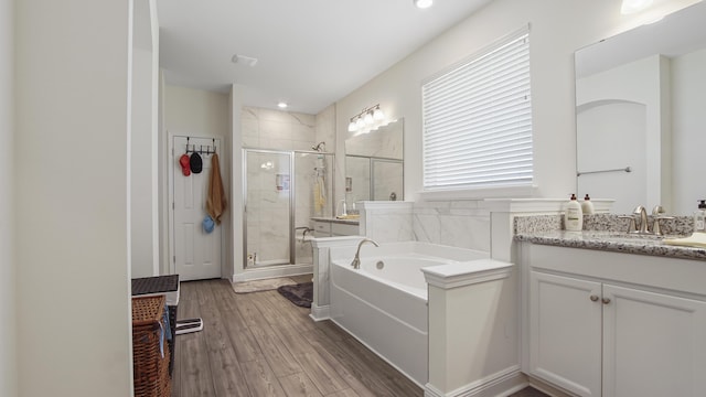 279 Tournament Ln, Freeport, FL 32439 - bathroom with recessed lighting, a shower stall, vanity, wood finished floors, and a bath