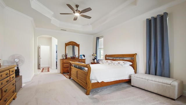 279 Tournament Ln, Freeport, FL 32439 - bedroom featuring arched walkways, a ceiling fan, light colored carpet, a tray ceiling, and crown molding