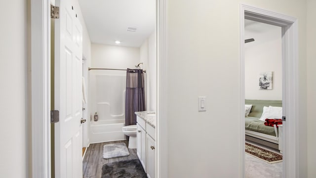 279 Tournament Ln, Freeport, FL 32439 - bathroom with toilet, ensuite bath, shower / tub combo with curtain, wood finished floors, and vanity