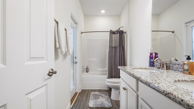279 Tournament Ln, Freeport, FL 32439 - bathroom featuring toilet, wood finished floors, a sink, double vanity, and shower / bath combo