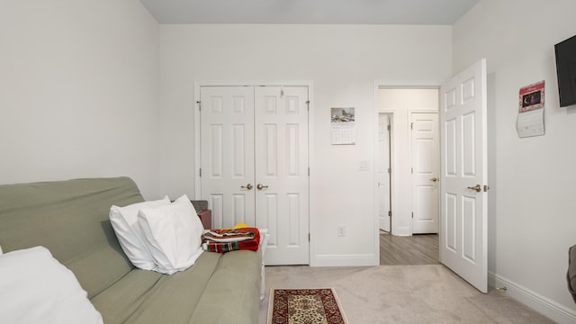 279 Tournament Ln, Freeport, FL 32439 - bedroom featuring baseboards, a closet, and light colored carpet