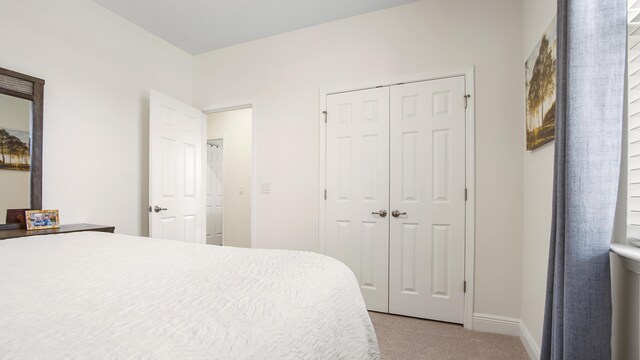 279 Tournament Ln, Freeport, FL 32439 - bedroom with a closet, light carpet, and baseboards