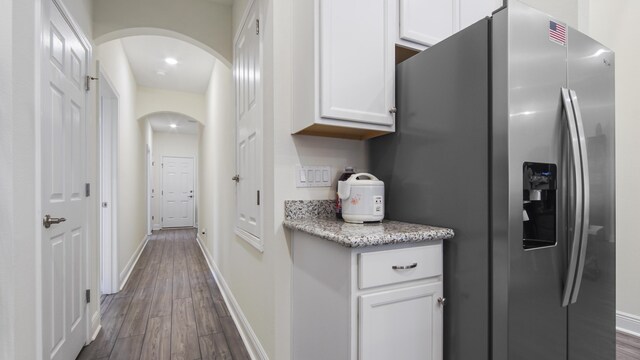 279 Tournament Ln, Freeport, FL 32439 - hall featuring arched walkways, dark wood finished floors, and baseboards