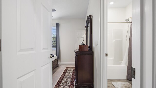 279 Tournament Ln, Freeport, FL 32439 - interior space featuring wood finished floors, shower / bath combo with shower curtain, vanity, and baseboards