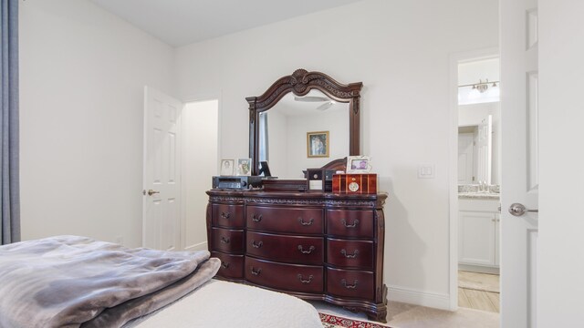 279 Tournament Ln, Freeport, FL 32439 - bedroom featuring connected bathroom, a sink, and baseboards