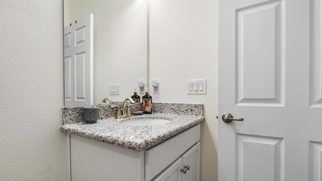 279 Tournament Ln, Freeport, FL 32439 - bathroom featuring a textured wall and vanity