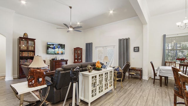 279 Tournament Ln, Freeport, FL 32439 - living room featuring light wood-style floors, crown molding, baseboards, and ceiling fan with notable chandelier