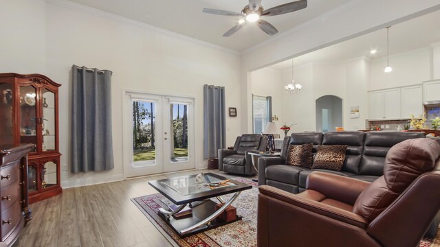 279 Tournament Ln, Freeport, FL 32439 - living room featuring arched walkways, wood finished floors, a high ceiling, crown molding, and ceiling fan with notable chandelier
