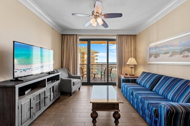 living area with a textured ceiling, wood finish floors, and crown molding