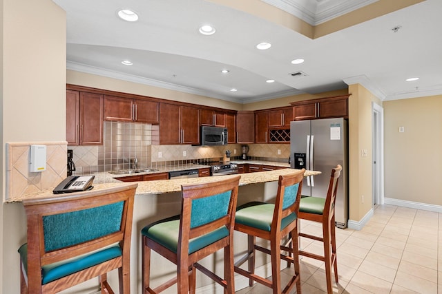 kitchen with visible vents, appliances with stainless steel finishes, ornamental molding, a sink, and a peninsula