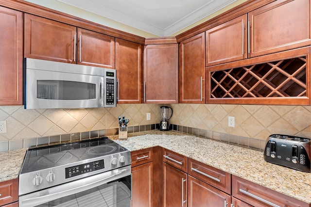 kitchen with stainless steel appliances, ornamental molding, and decorative backsplash