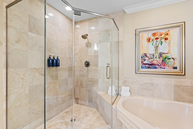 full bath featuring ornamental molding, a shower stall, and a bath