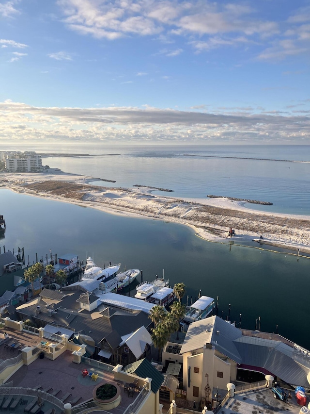 drone / aerial view with a water view and a beach view