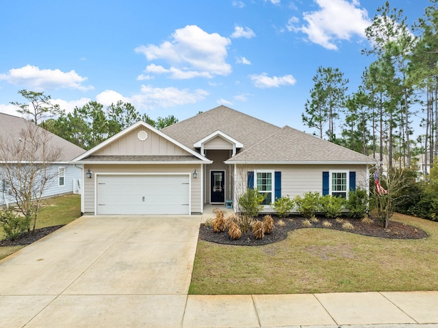 ranch-style house featuring an attached garage, a shingled roof, concrete driveway, board and batten siding, and a front yard