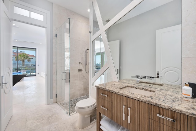 full bath with vanity, toilet, and a shower stall