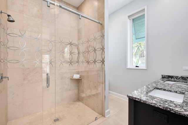 bathroom featuring a shower stall, baseboards, tile patterned flooring, and vanity