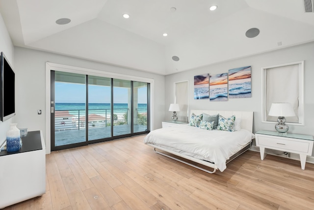 bedroom featuring access to exterior, light wood finished floors, recessed lighting, a raised ceiling, and vaulted ceiling