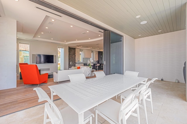 dining area featuring wood ceiling, a raised ceiling, visible vents, and recessed lighting